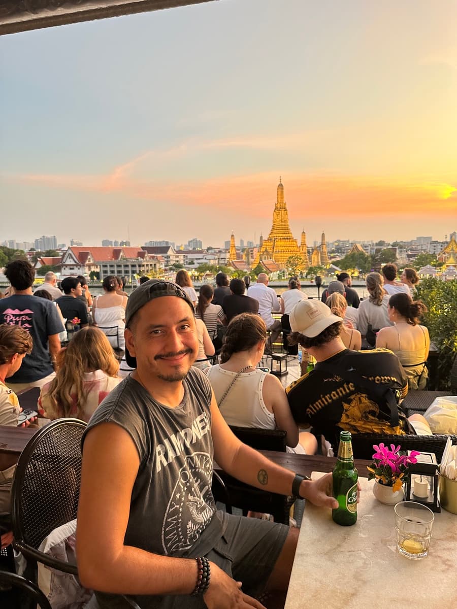 Arni at a rooftop bar overlooking Wat Arun at sunset