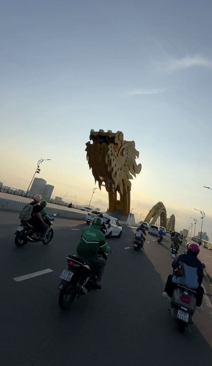 Riding across the Dragon Bridge at sunset