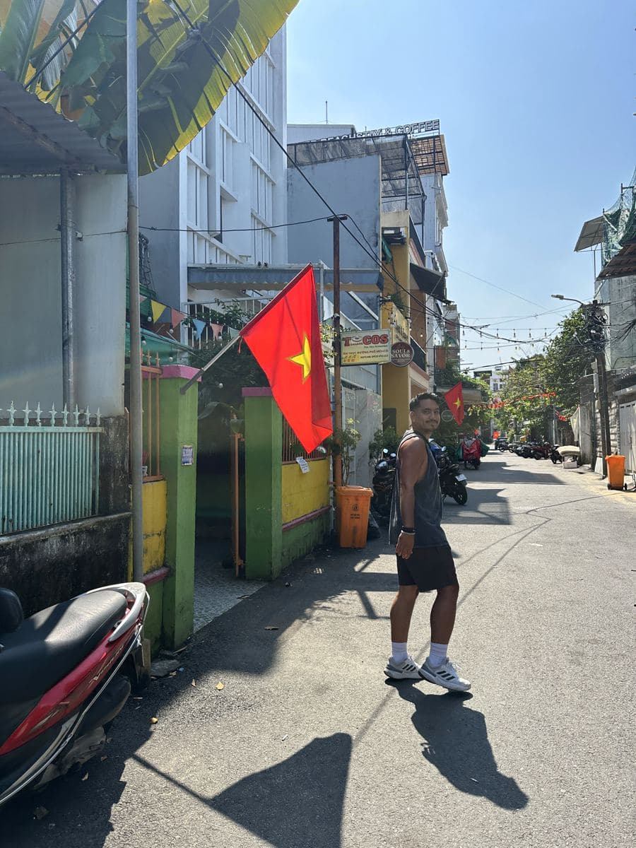 Arni in a flag-lined alley near the beach