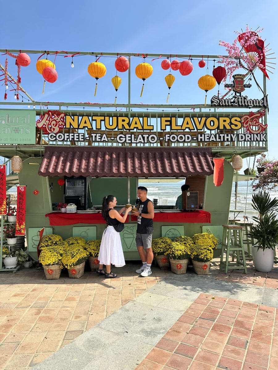Coffee at a beachfront cart under the lanterns